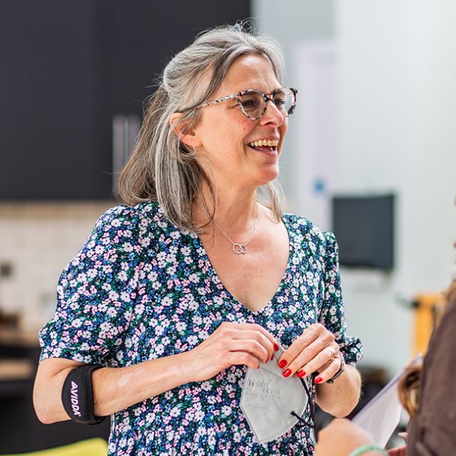 Photo of Nicola Mosley, chatting to a staff member.