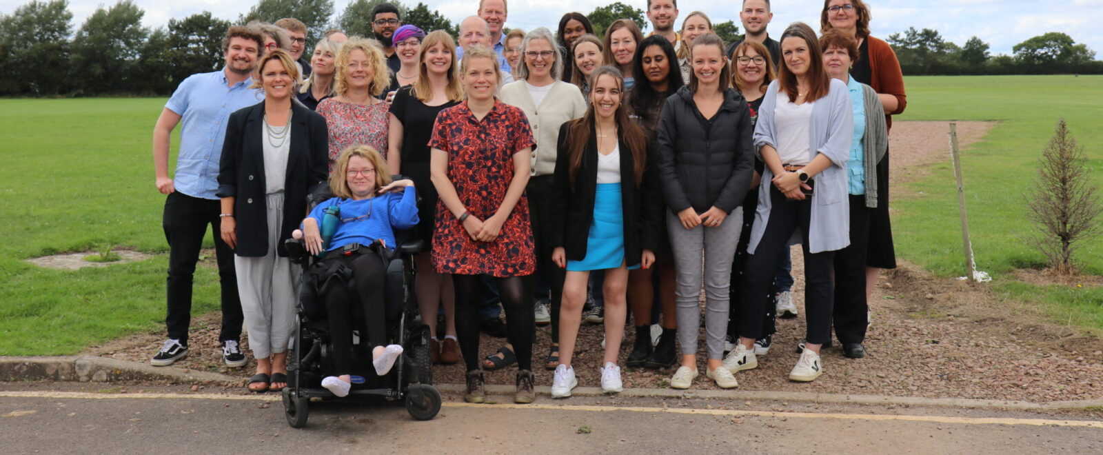 Photo shows a large group of Barnwood Trust staff posing for the camera in a group.