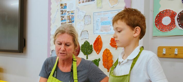 Woman helping boy to make sandwiches